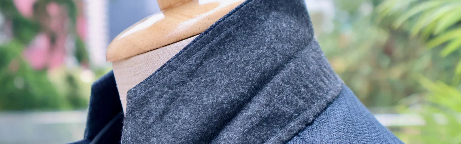 Textured blue bespoke jacket with a grey felt under-collar on a mannequin