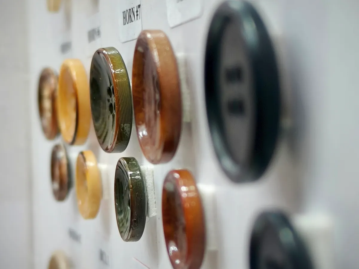 Board of horn and resin suit buttons in different colours and sizes