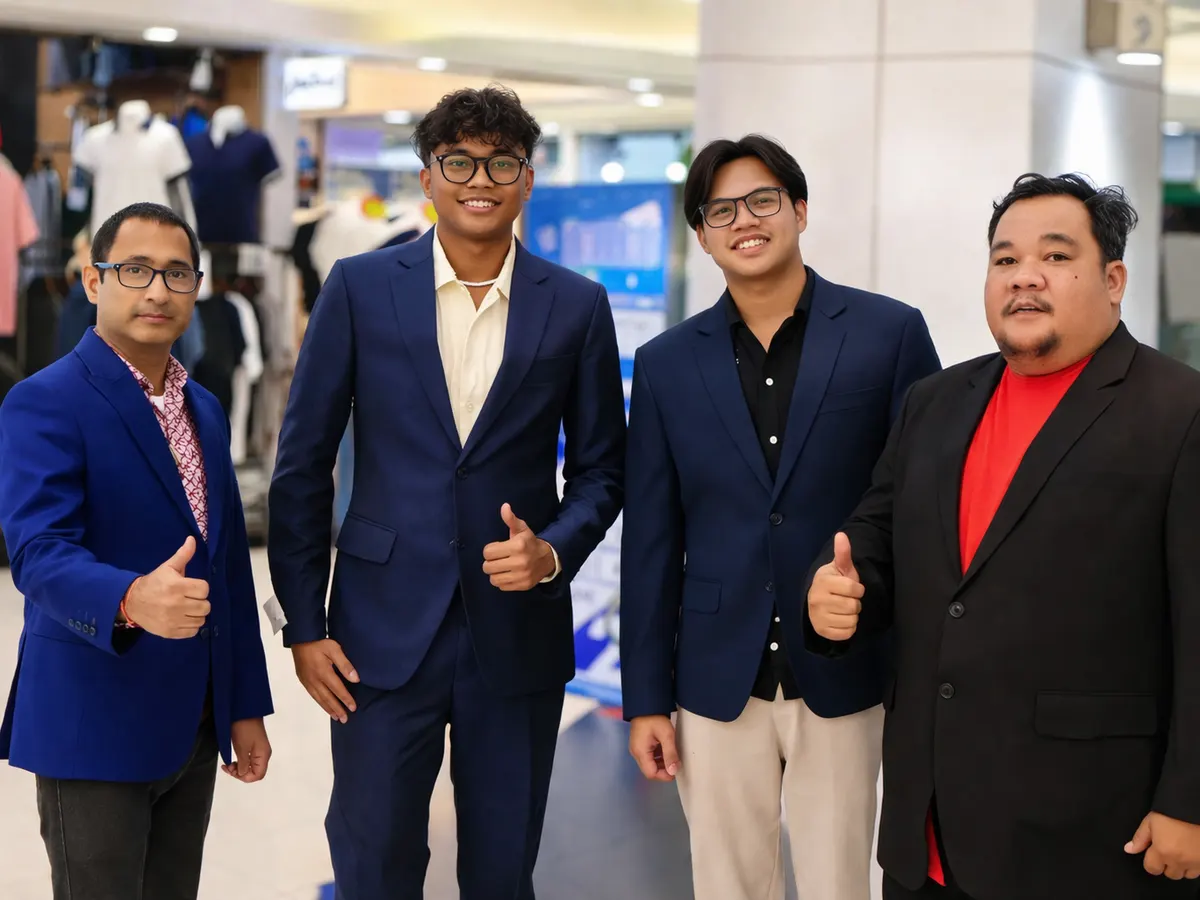 Four men in tailored blazers giving a thumbs up together in a shopping mall