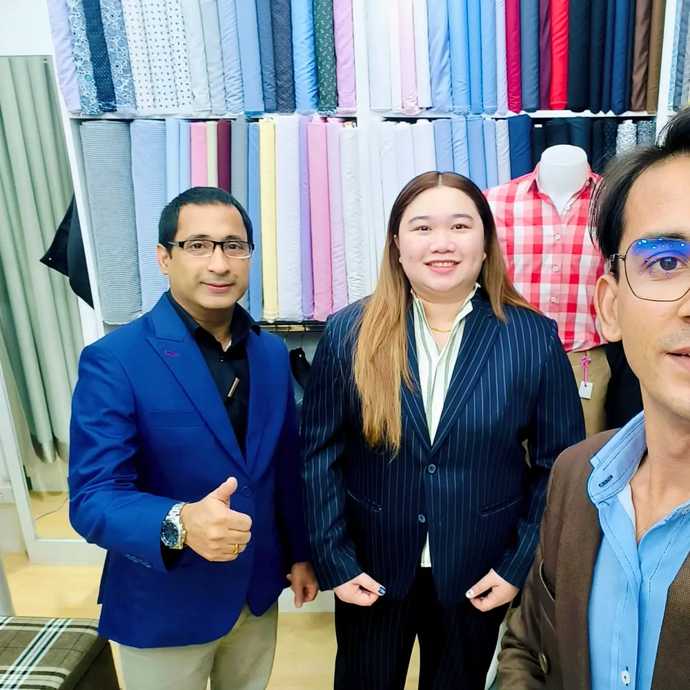 ITORVANI team members posing together in front of the fabric wall