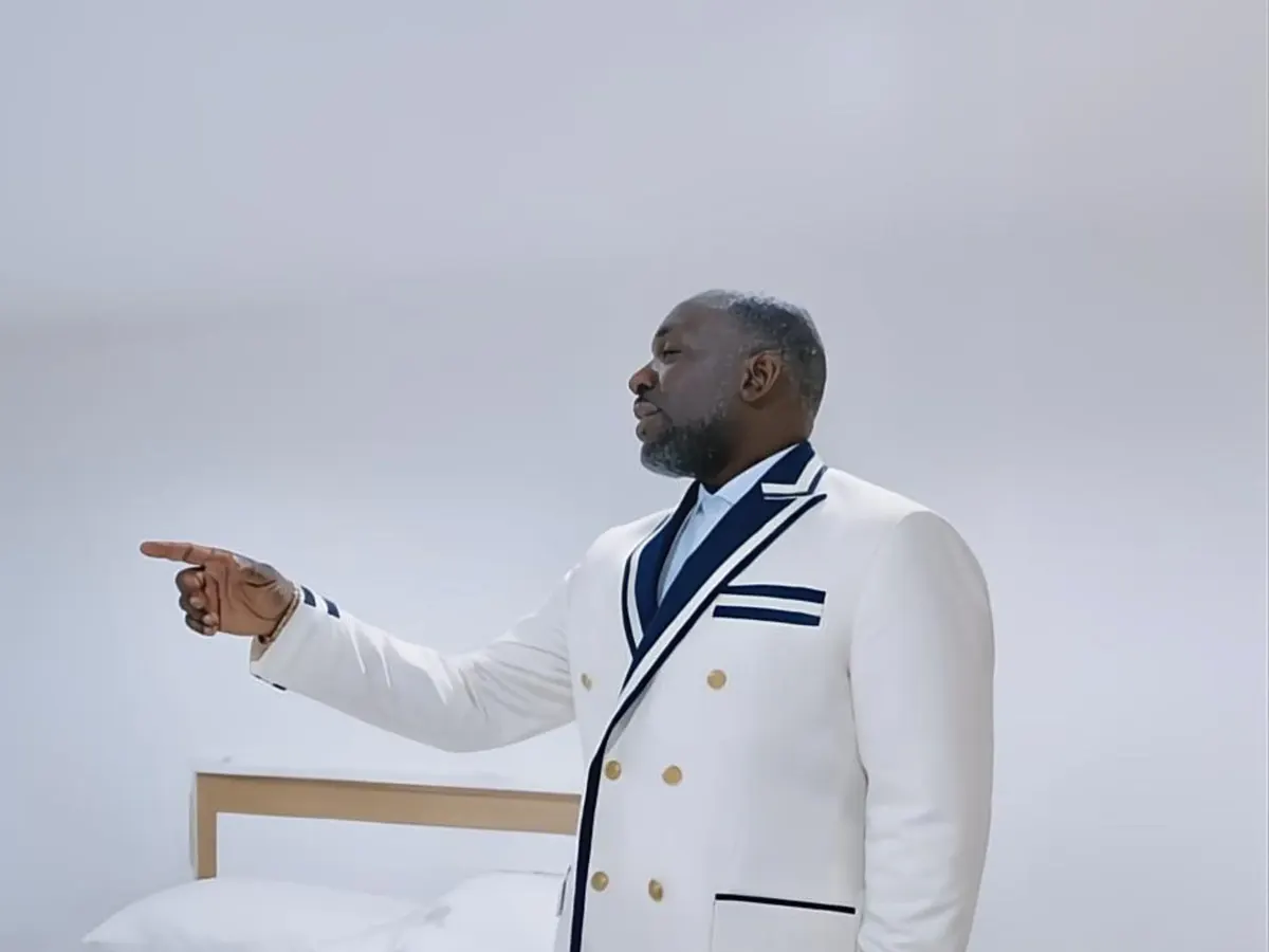 Client in a white double-breasted dinner jacket with navy piping in a bright private room